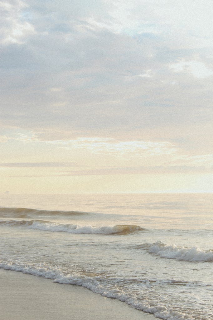 Peaceful morning scene of waves gently reaching the shore at Bethany Beach, Delaware.